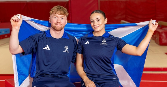 Cameron Lynn and Crystelle Lake holding Scottish flag