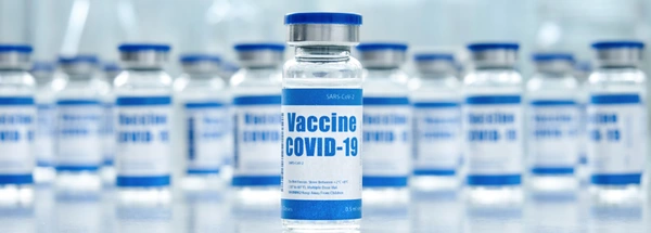 Vials of clear liquid marked with COVID-19 vaccine labels