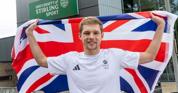 Duncan Scott poses with Union Flag outside University of Stirling Sports Centre.
