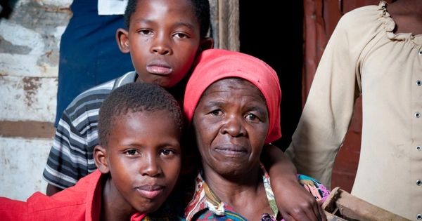 older black woman with two young boys