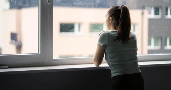 woman looking out of window