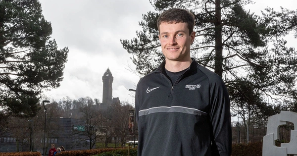 Marc Austin standing in front of the Wallace Monument, Stirling