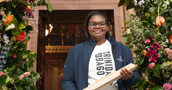 Gabriella Wood smiling whilst holding a baton