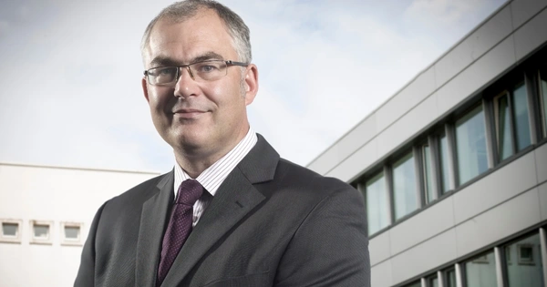 man in suit with buildings behind