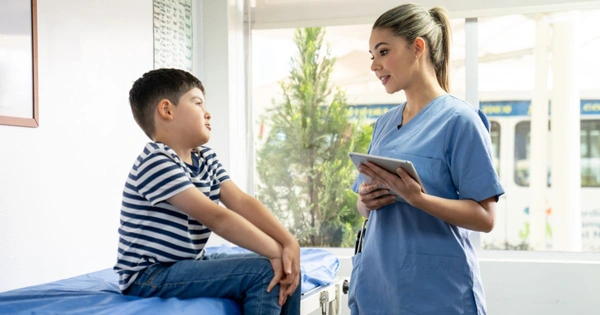 A nurse speaks to a primary school age child