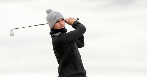 George Cannon hits a golf shot.