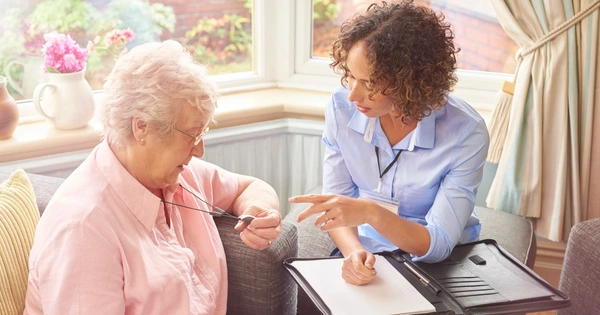 Older woman and carer at home