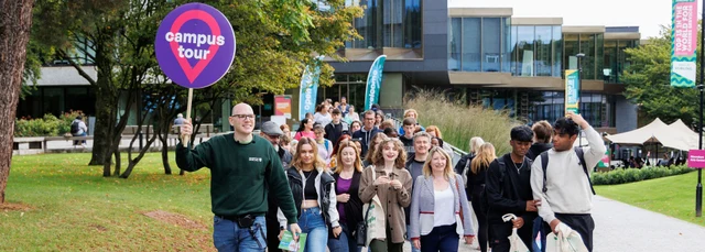 A group of happy prospective students on a campus tour at the University of Stirling