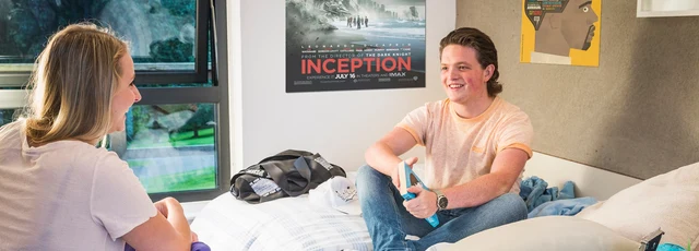 Students talking in a room in the university accommodation