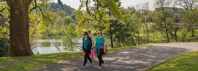 Students walking next to loch