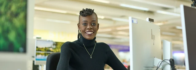 Postgraduate student sat at a computer in the library