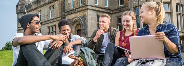 University of Stirling students socialising outside Airthrey Castle.