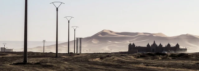 old building and electric cables in desert