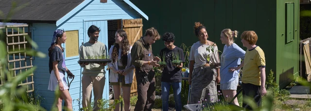 Group of people outside garden shed