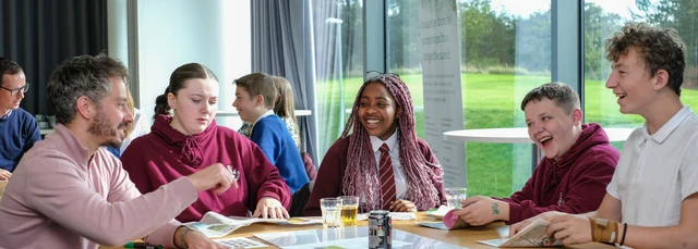 School children sat around a table with mentors