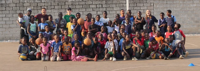Group photo of volunteers, coaches and school children