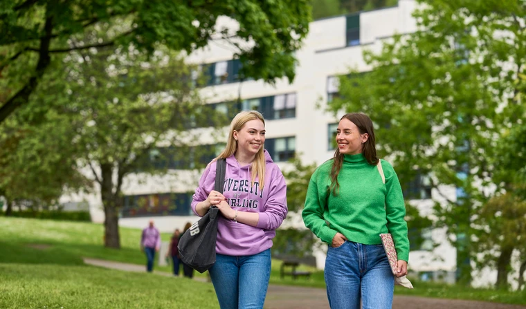 Two students walking near accommodation building