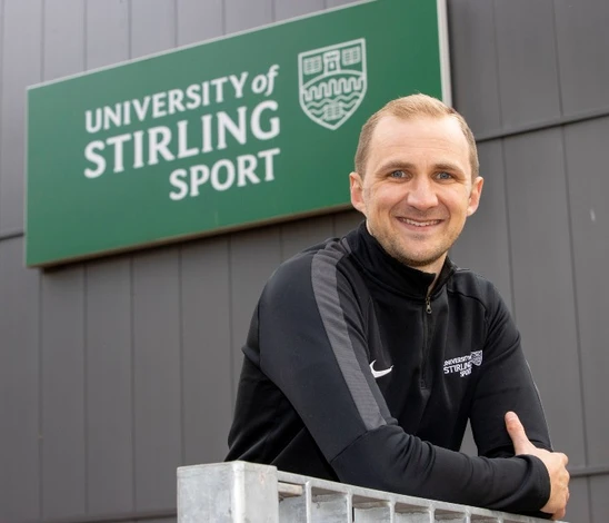 David Bond pictured in front of University of Stirling Sport signage.