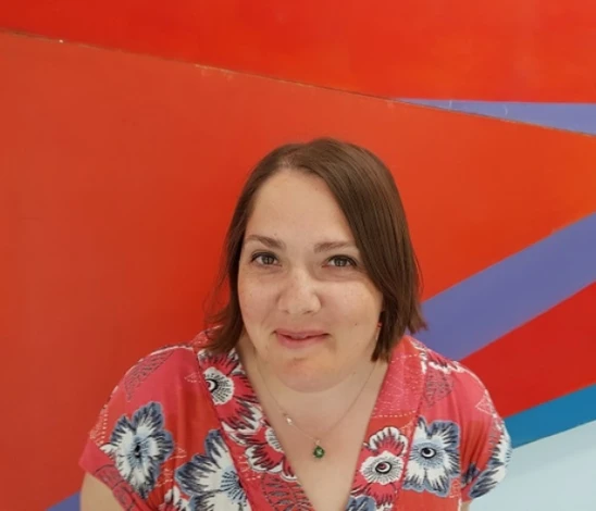 woman looking at camera with red background