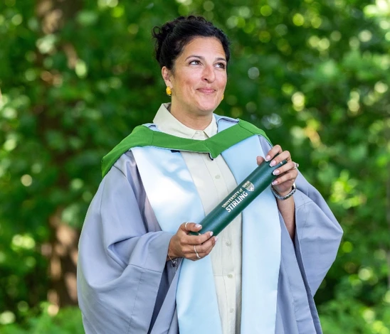 Shumela Ahmed-Poole poses with scroll.