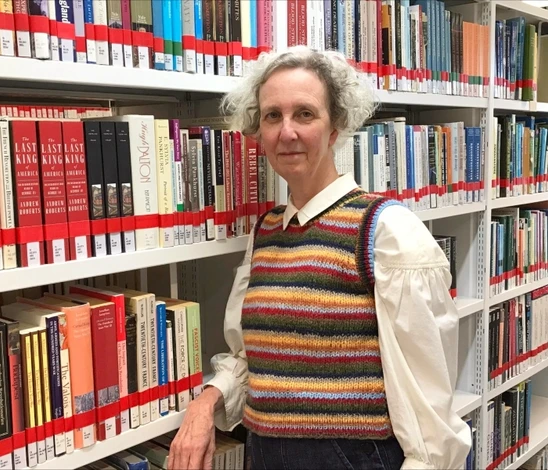 Woman standing in front of shelves of books