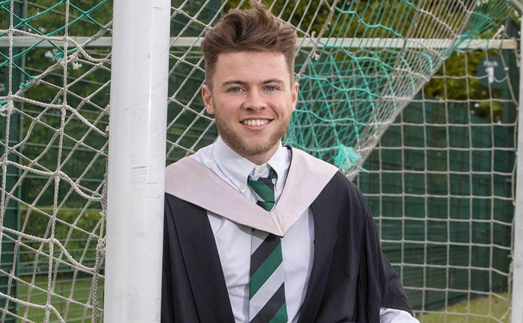 Footballer Craig Brown in graduation robes