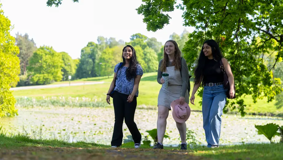 Three students walking on campus