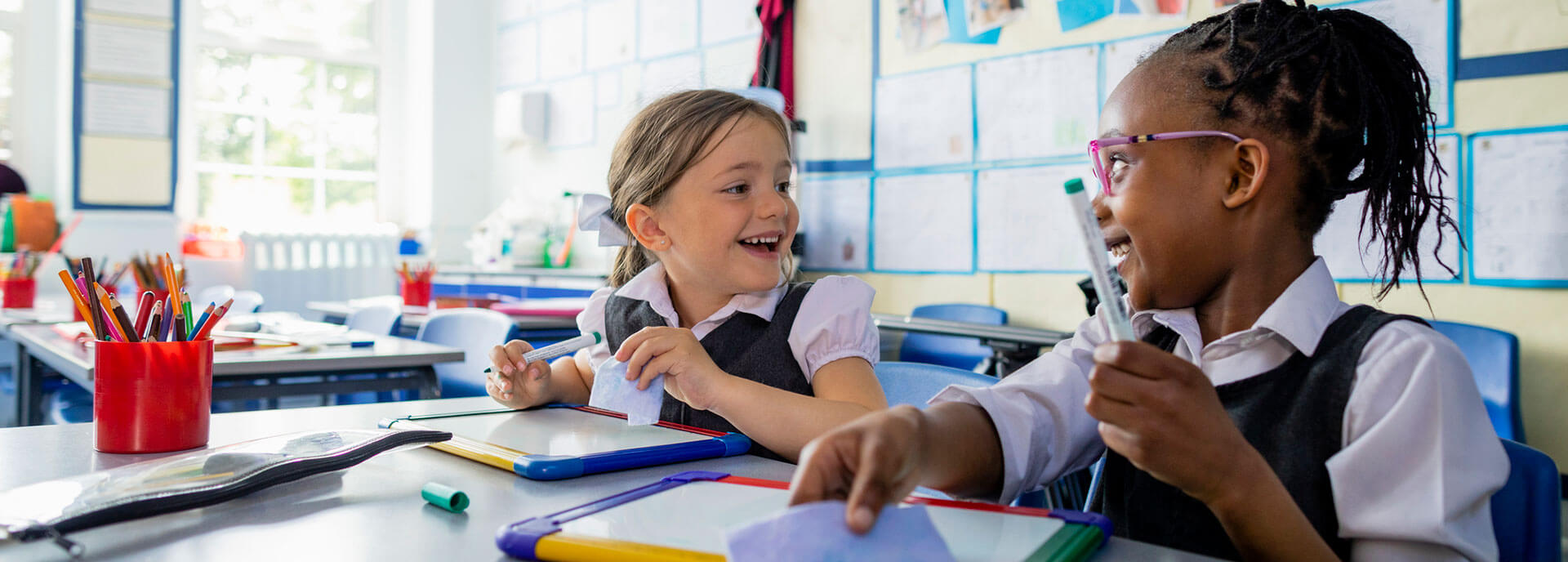 Two children having fun in a classroom