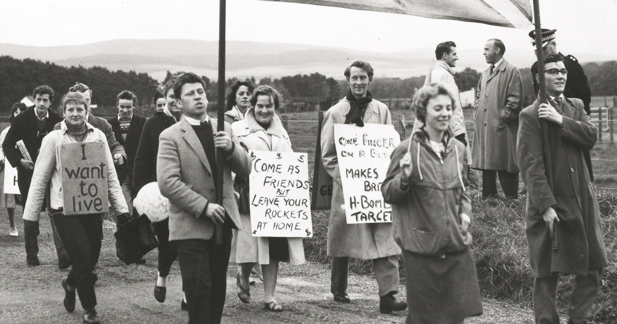 People in a peace march holding signs
